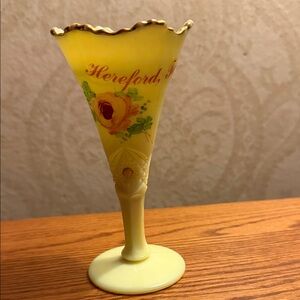 Vintage custard glass vase glowing under UV light